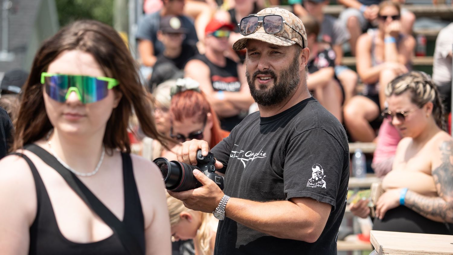 Outdoor summer event with crowd gathered in casual attire.