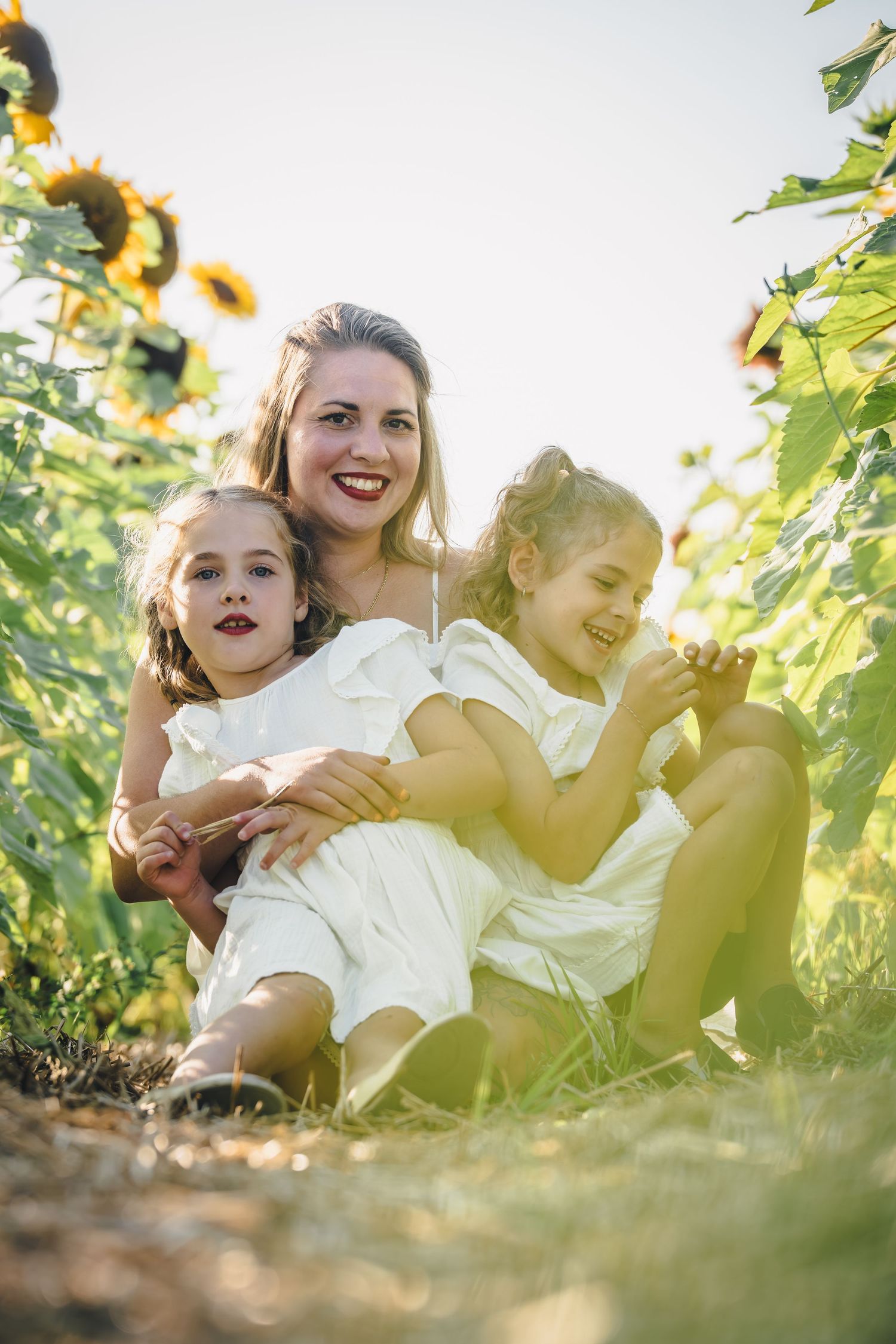 Group relaxing together among sunflowers in a sunny garden setting.