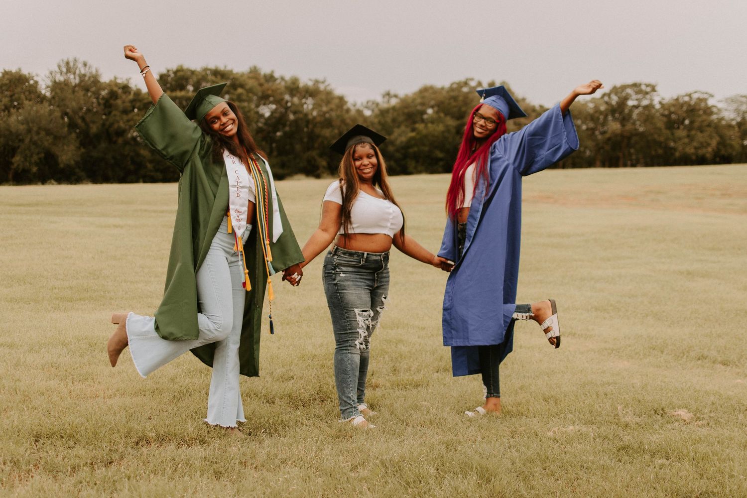 Group photo session in an open field with people wearing casual coordinated outfits.