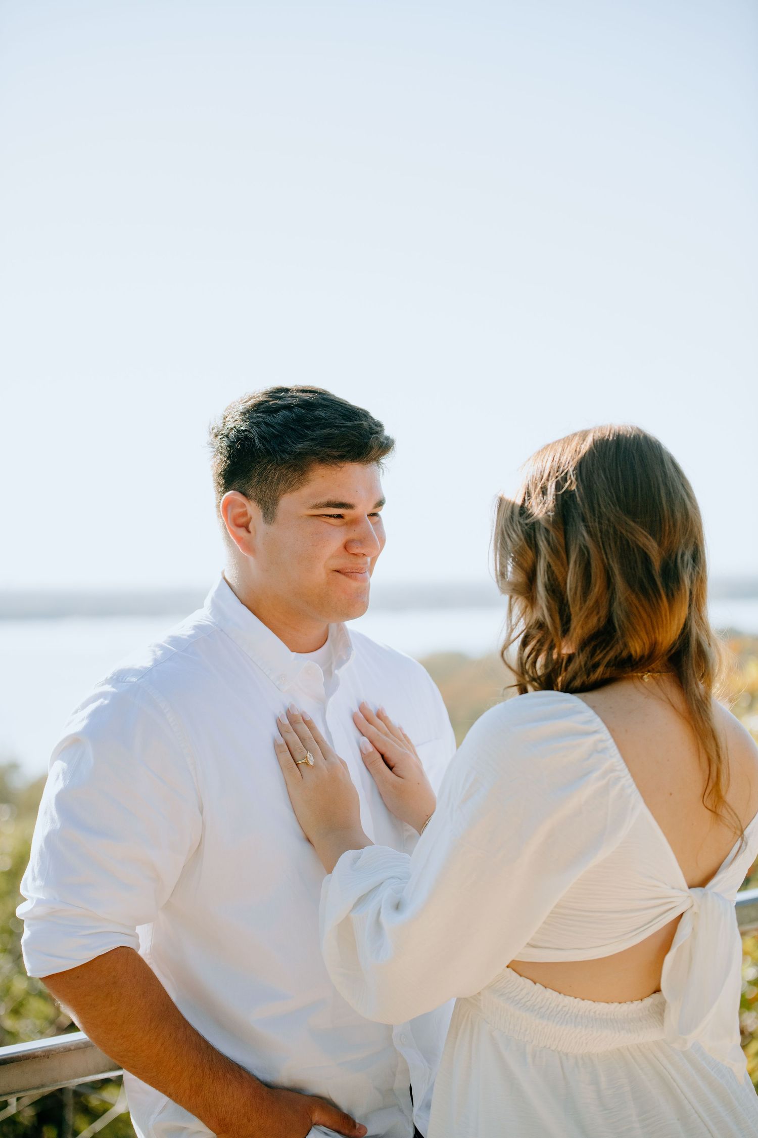 A couple in white outfits sharing intimate moments in a series of candid photos on a bright sunny day.