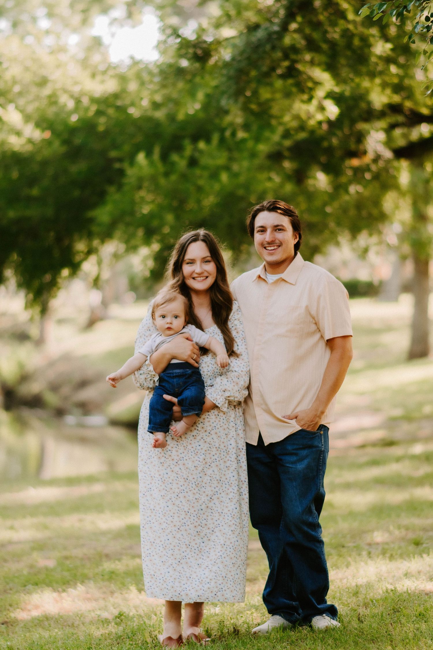 A casual outdoor family portrait session with children in a natural park setting.