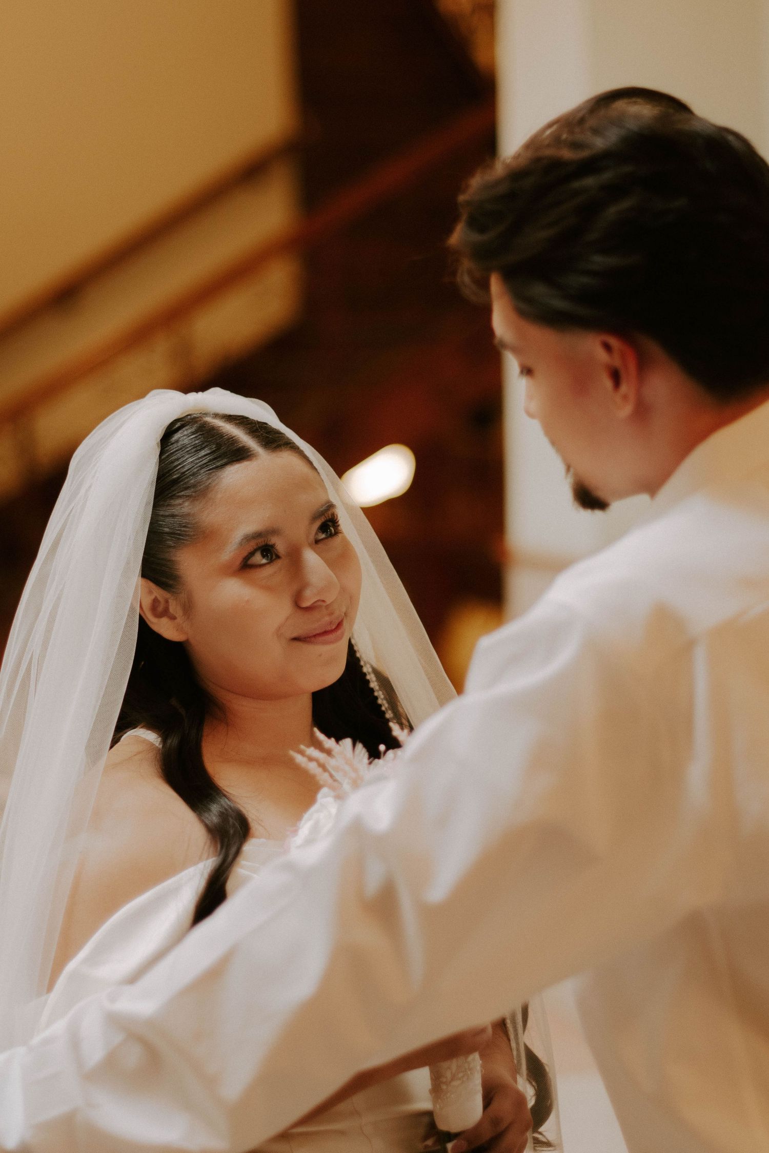Intimate moment between bride and groom during their wedding ceremony.