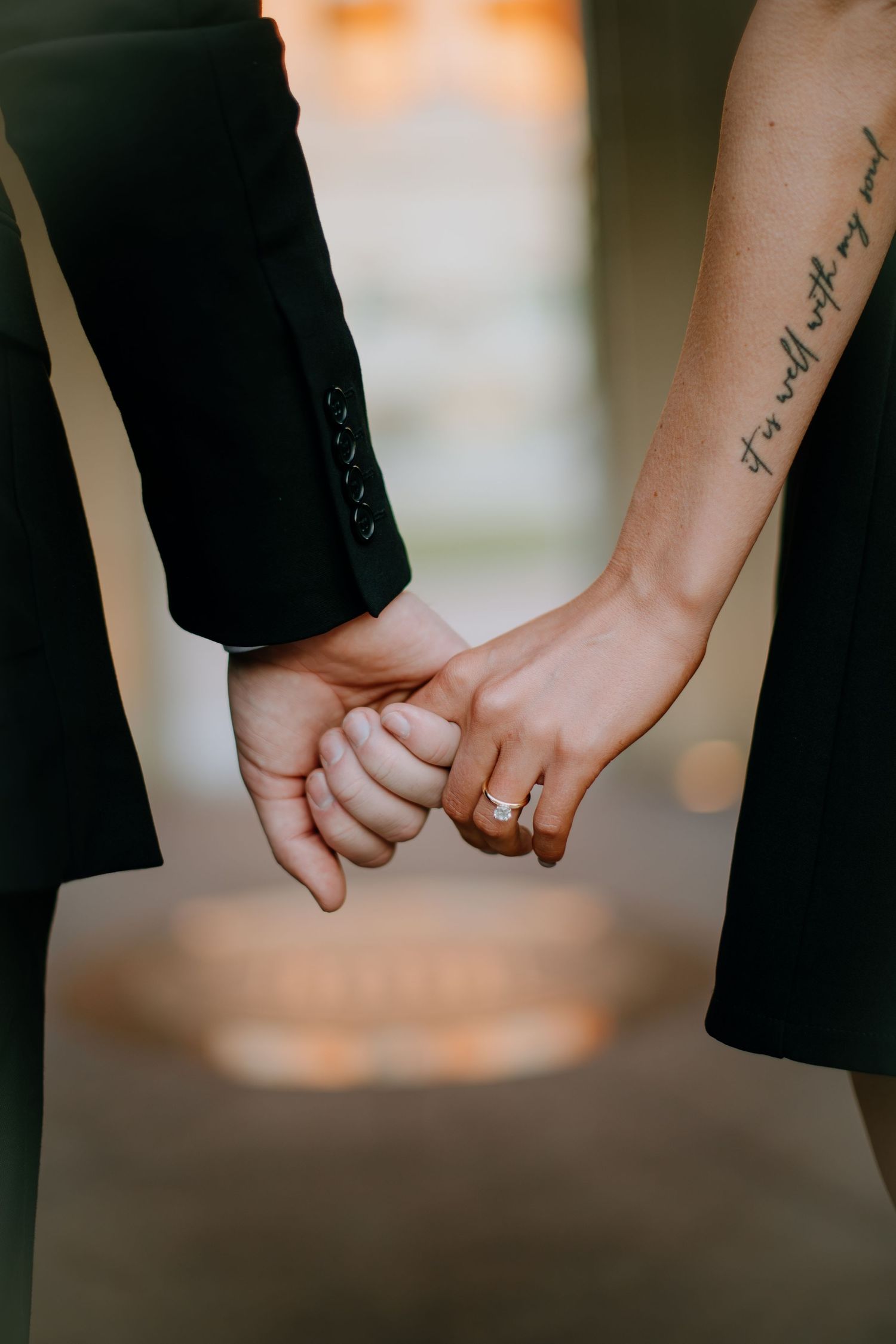 Close-up shots of two hands holding each other tenderly with a ring visible.