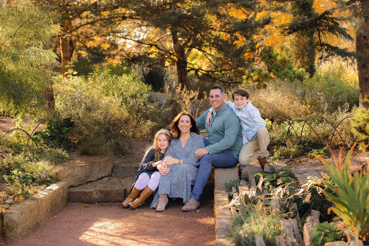 A series of outdoor family portraits taken in a desert garden setting with warm golden sunlight filtering through trees.