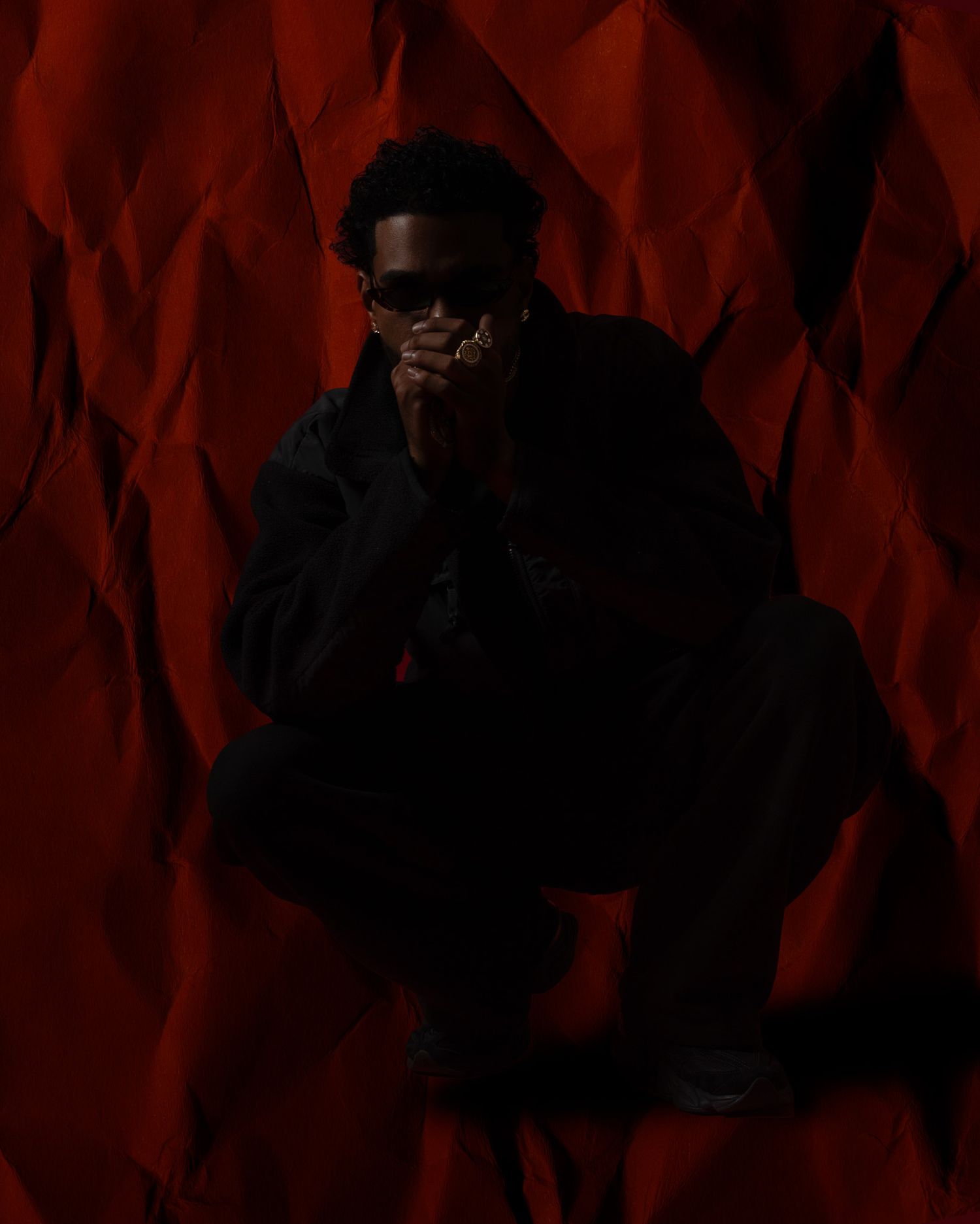 Dark artistic portrait with red geometric background patterns.