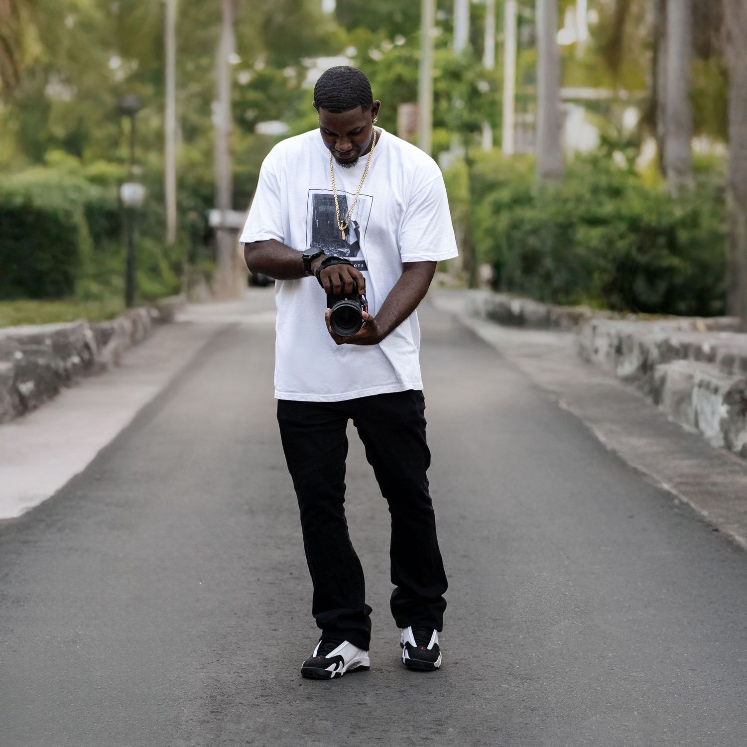 Person in white t-shirt and dark pants standing on urban sidewalk demonstrating different poses.