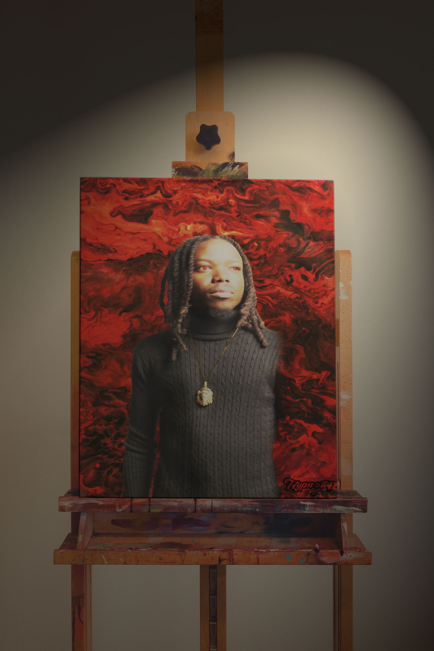 Portrait displayed on wooden easel against red backdrop with dramatic spotlight effect.