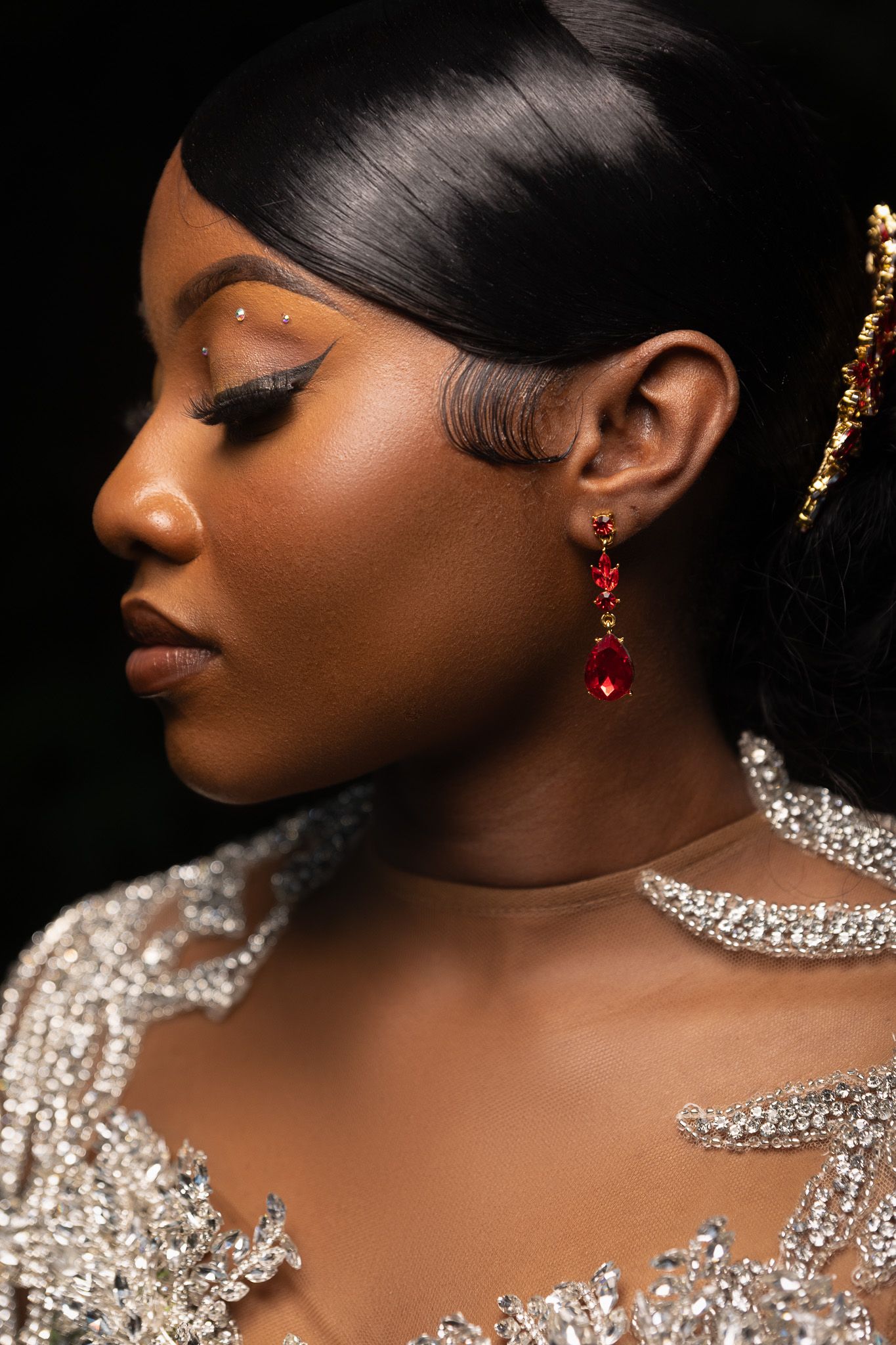 Close-up beauty shots highlighting sparkling jewelry and dramatic makeup against dark background.