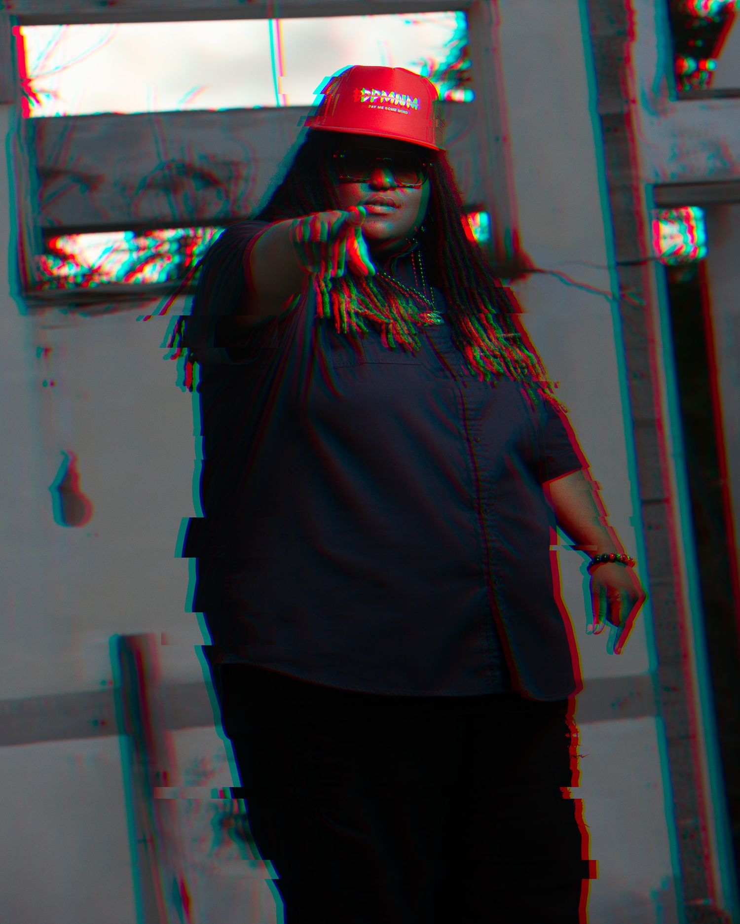 Group photo with red caps and dark outfits with glitch effect overlay.