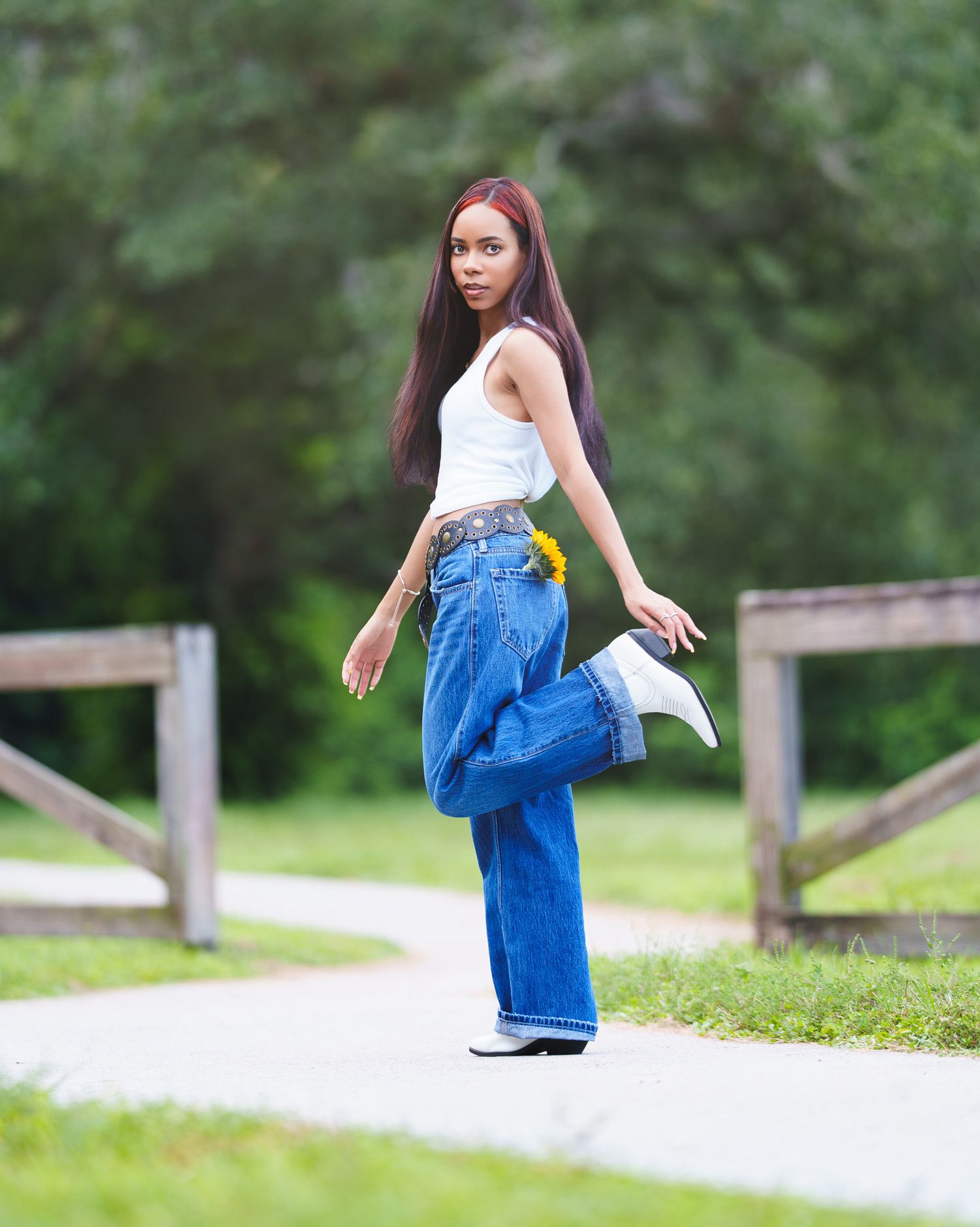 Woman walking along a park path in natural light.