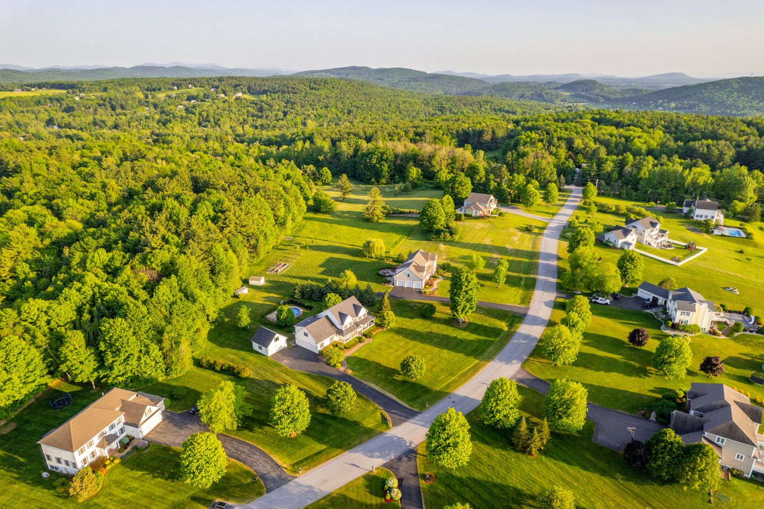 Aerial view of upscale suburban development with spacious lots and winding roads.
