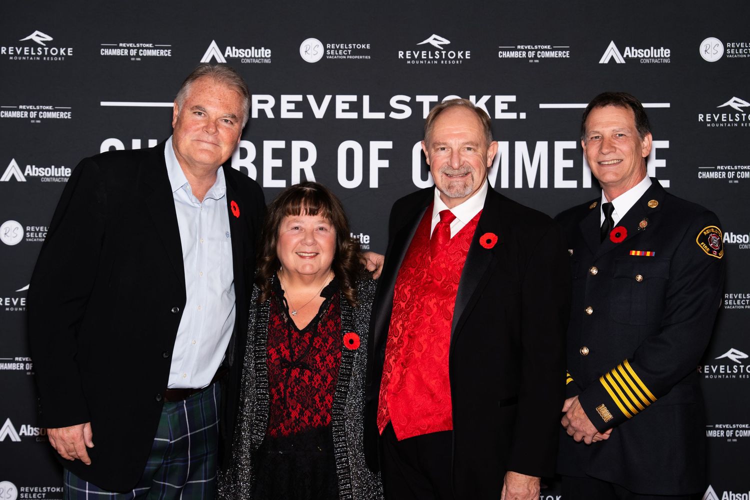 Group of people in formal attire posing together at a Revelstoke Chamber of Commerce event.