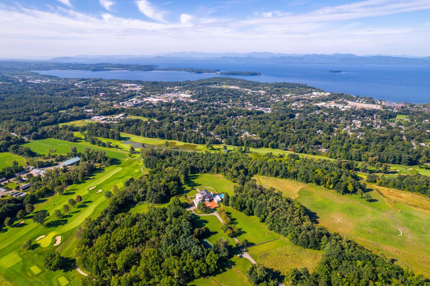 Panoramic aerial view of coastal landscape with islands dotting the blue ocean waters.