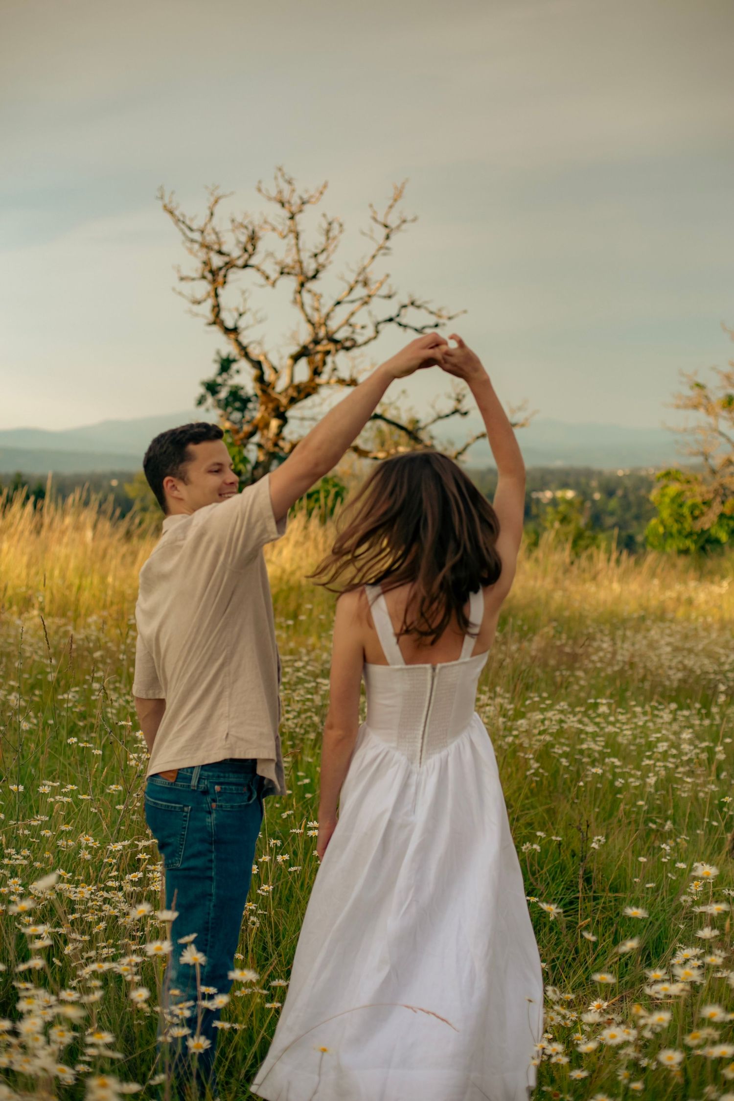 A man and woman dancing in a field of wildflowers
