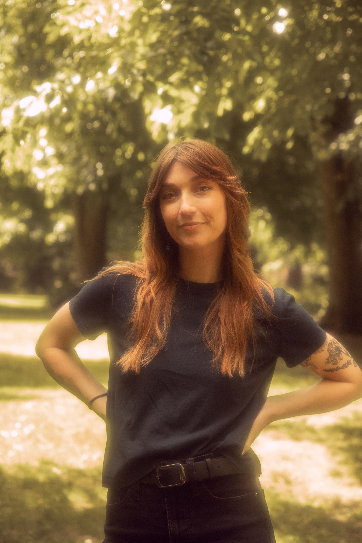A woman poses for a solo portrait photoshoot in a park in Portland, Oregon