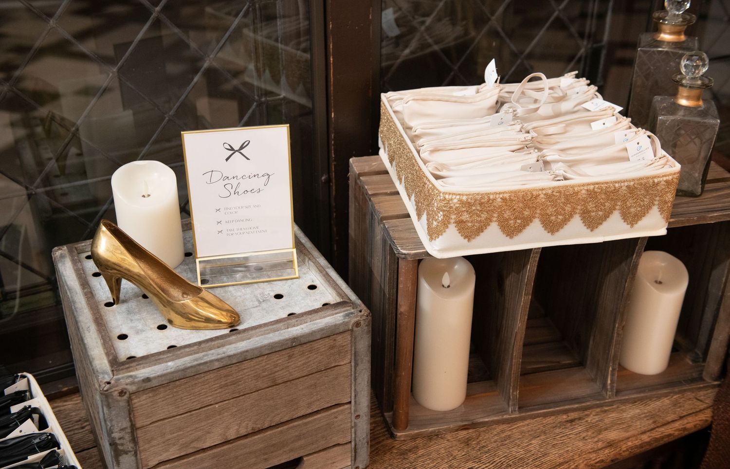 Rustic wooden display tables showcase vintage-style wedding decorations and party favors.