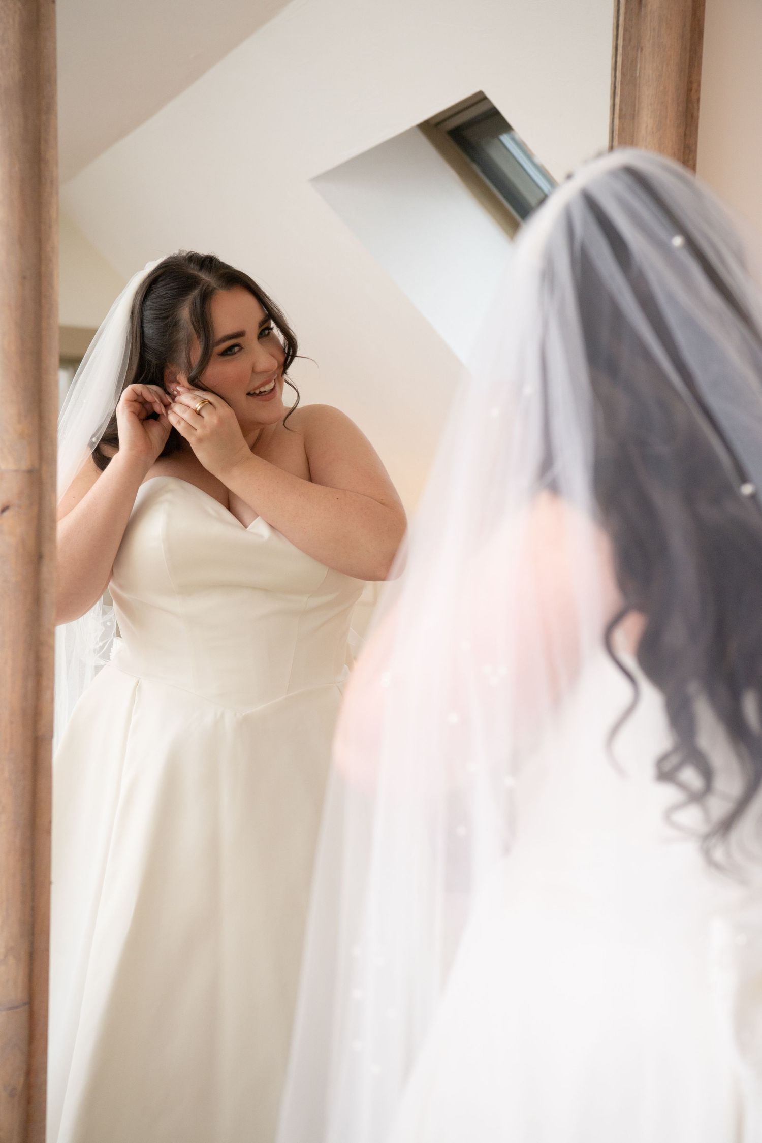 A series of artistic wedding dress portraits showing flowing white fabric against a light interior background.