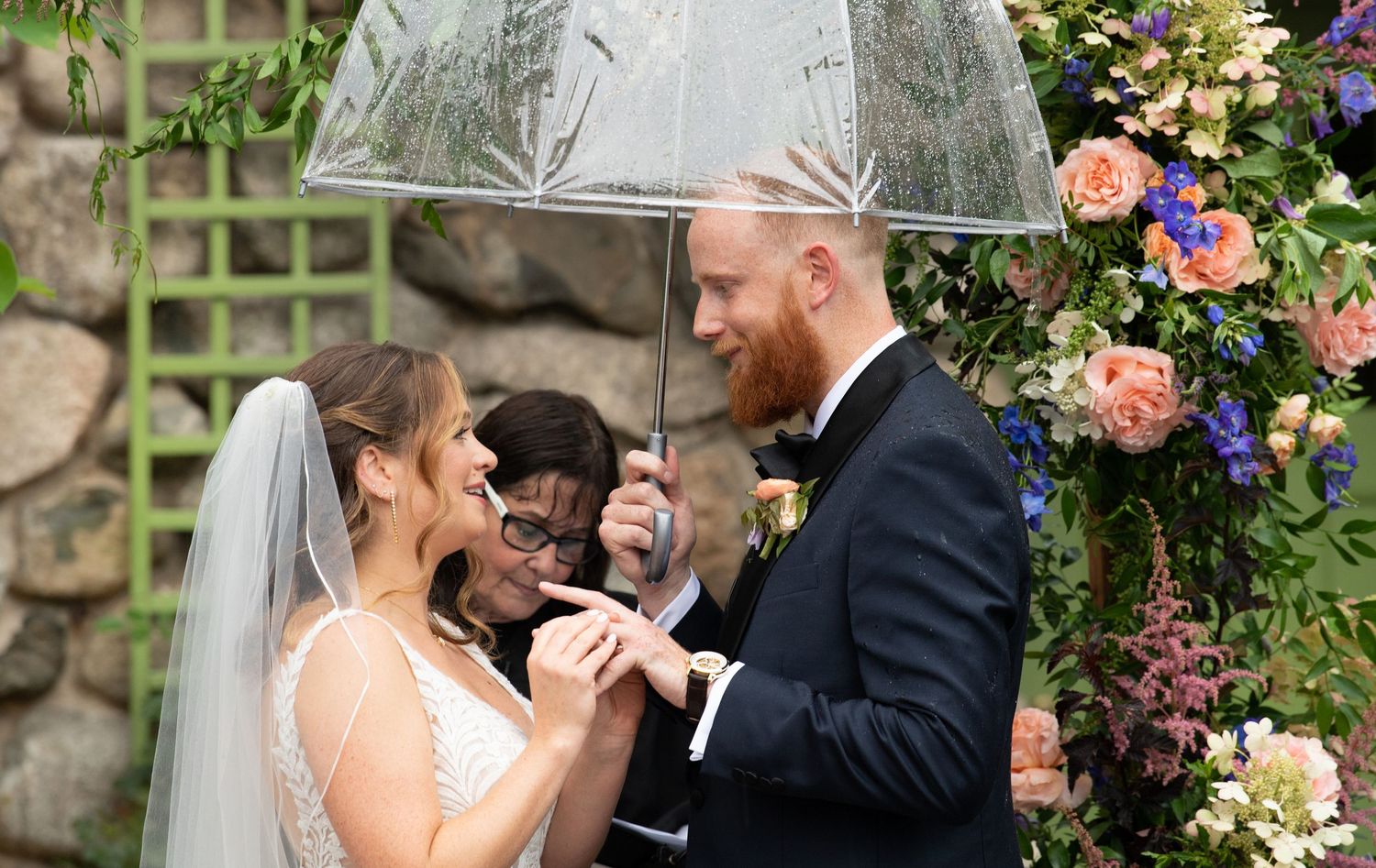 A romantic wedding couple shares tender moments in a garden setting with beautiful floral arrangements and decor.