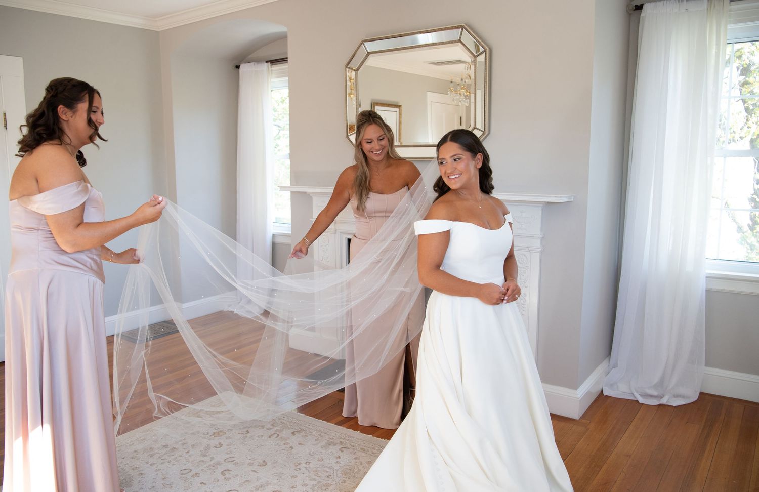 A series of wedding preparation photos showing flowing white dresses and veils in a bright sunlit room.