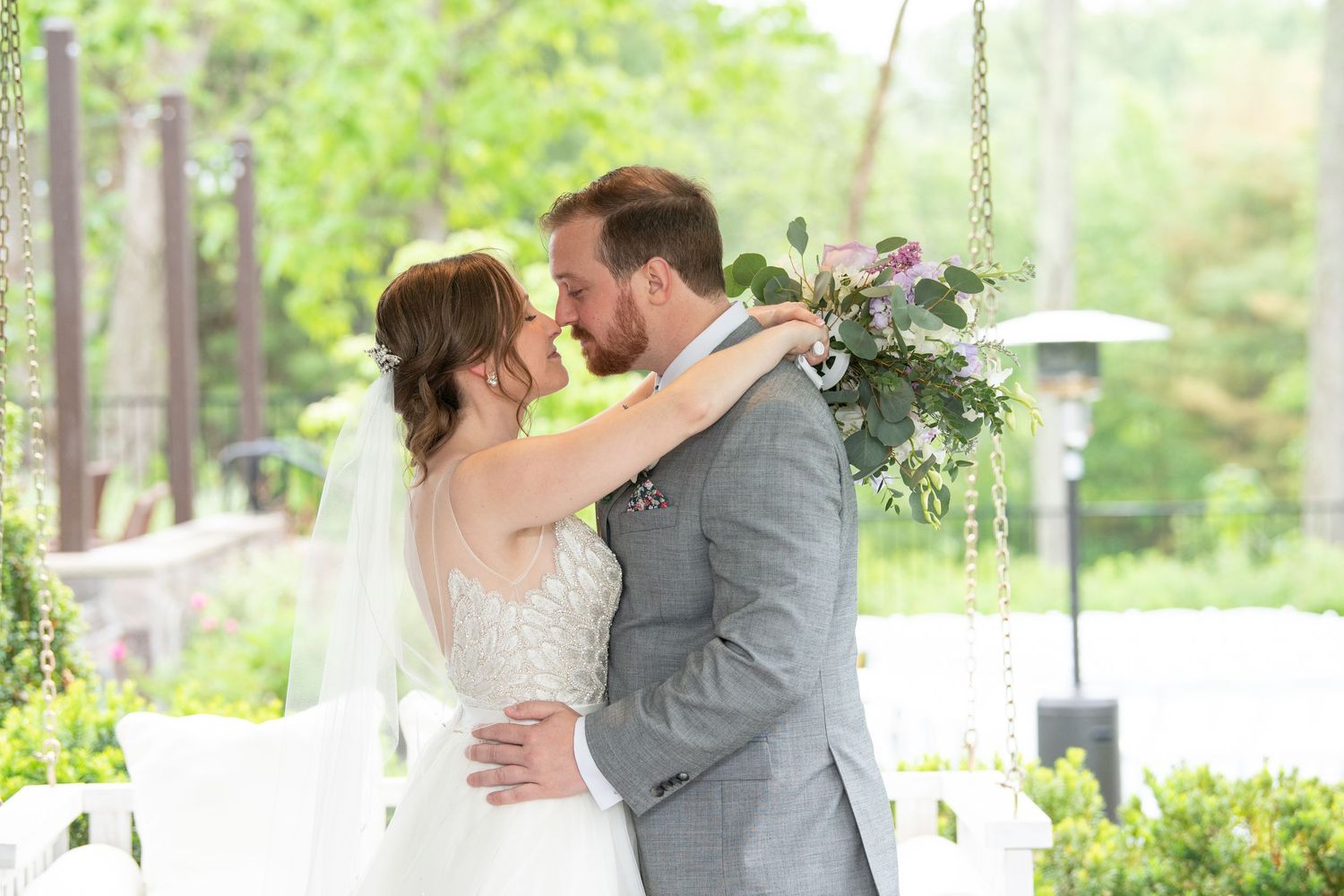 Romantic outdoor wedding portraits in a lush garden setting with natural greenery and soft lighting.