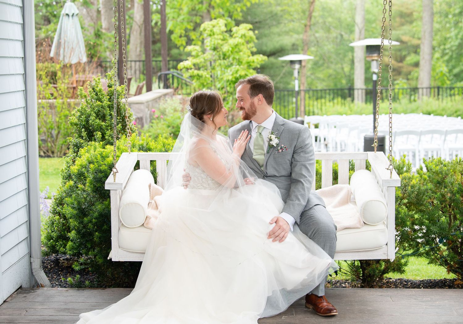 A collage of wedding photos showing romantic moments on a porch with white columns and lush greenery in the background.