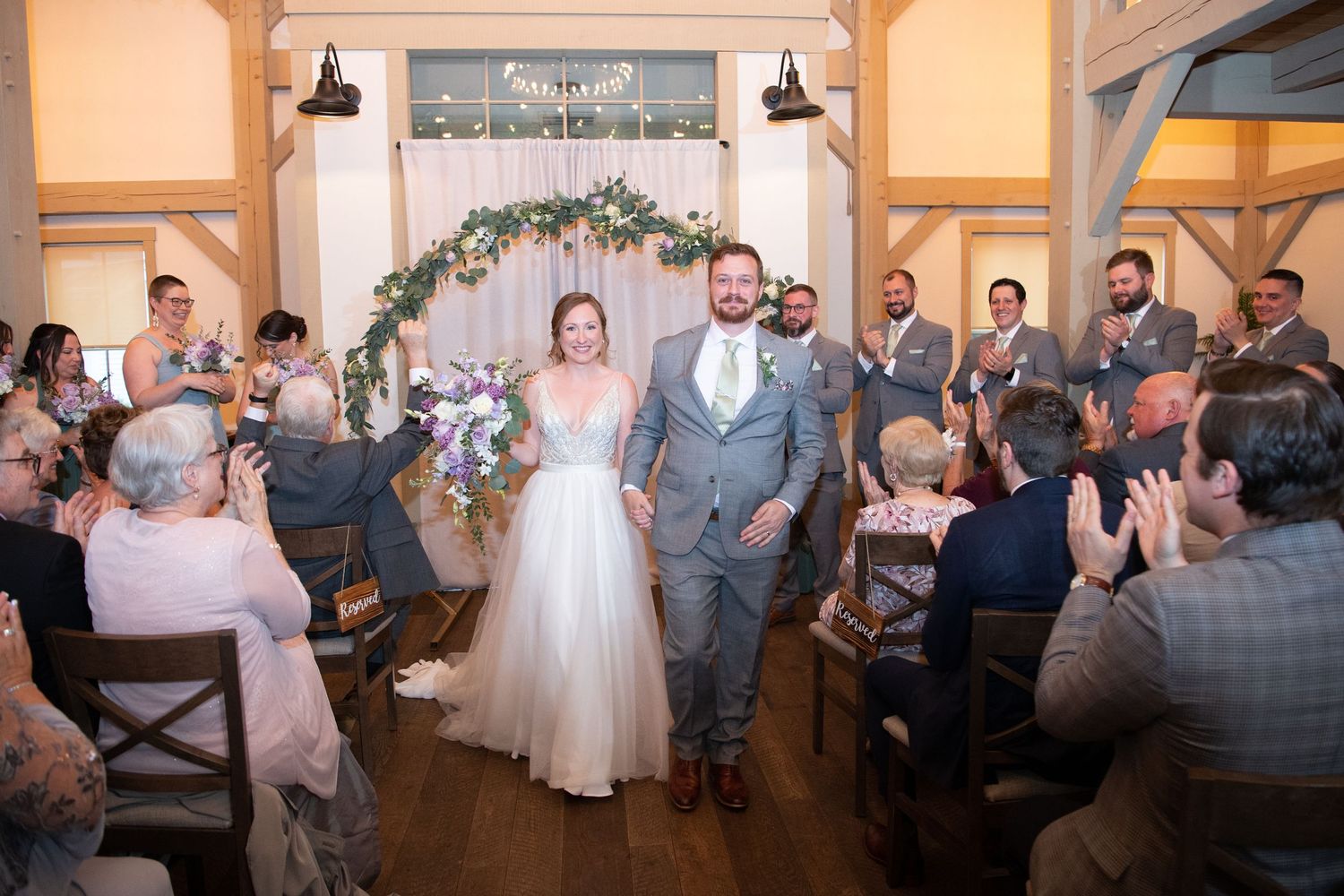 Panoramic view of wedding ceremony moments with bridal party in grey and sage green attire.
