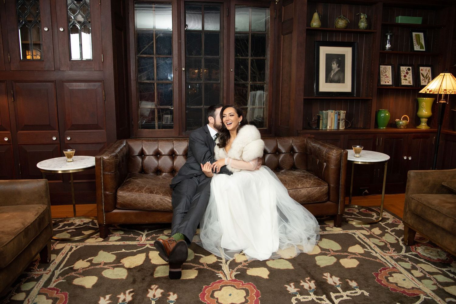 Traditional wedding ceremony setup with elegant decor in a dark wood-paneled room.