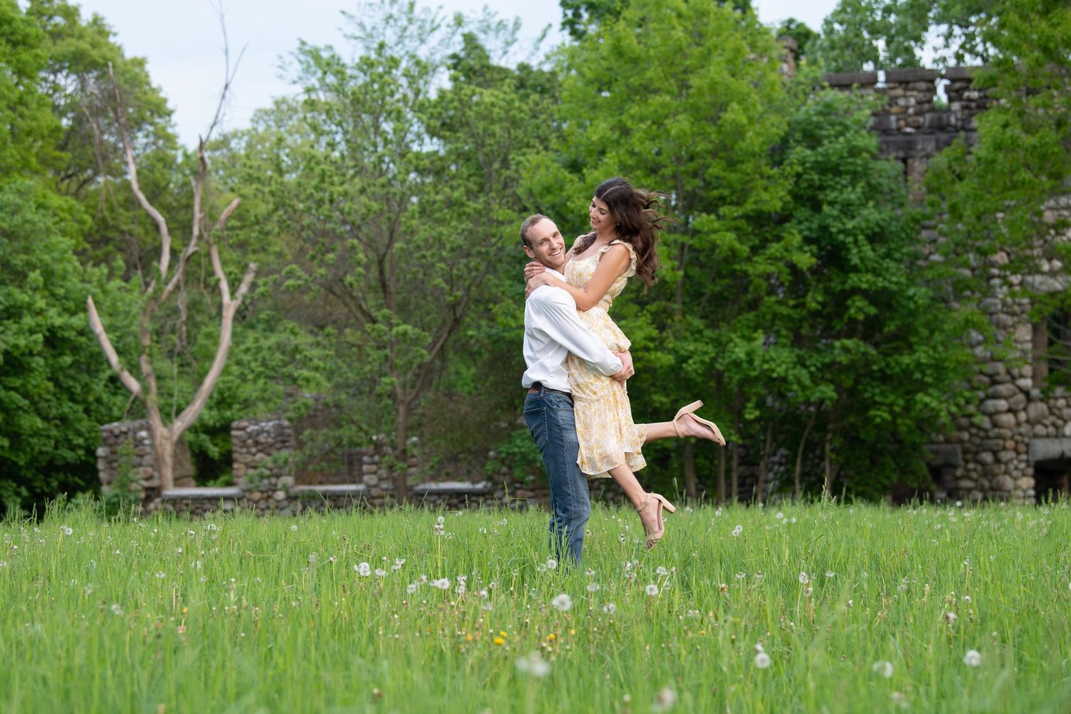 A series of romantic couple photos in a lush green meadow filled with dandelions showing tender embraces and playful moments.