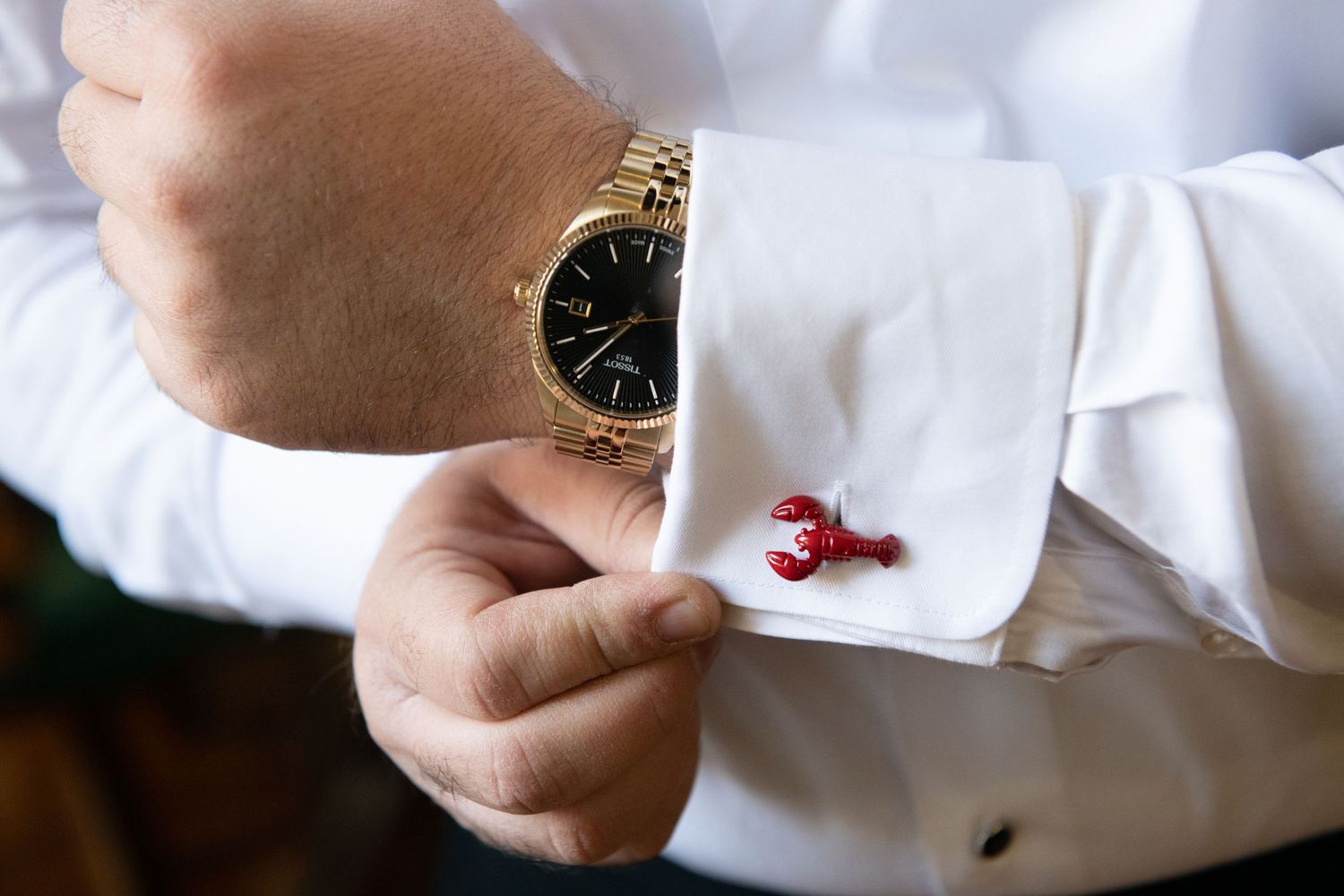 A hand holds a white napkin or tissue paper against a light background.
