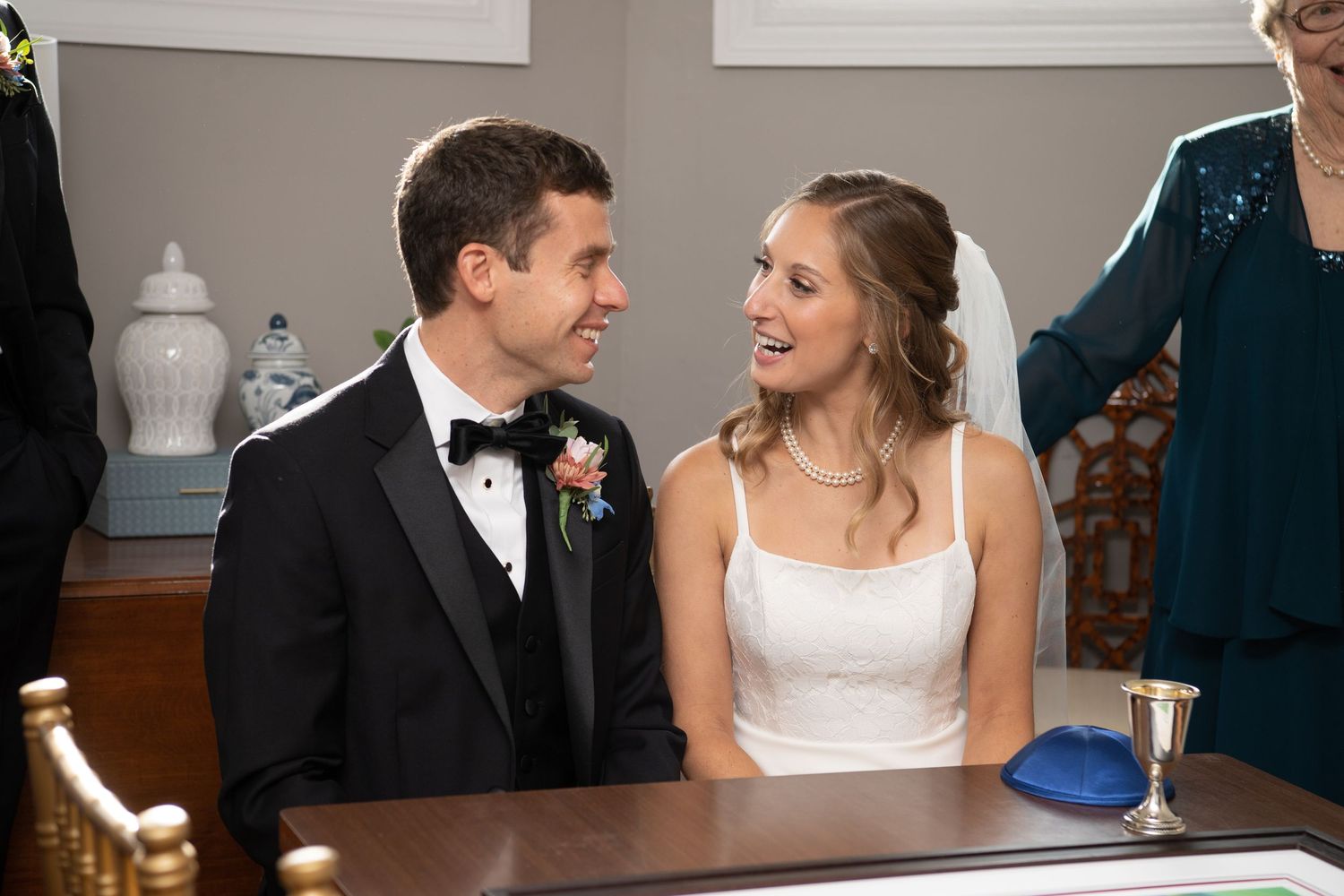 Newlyweds share a joyful moment while signing their marriage license.