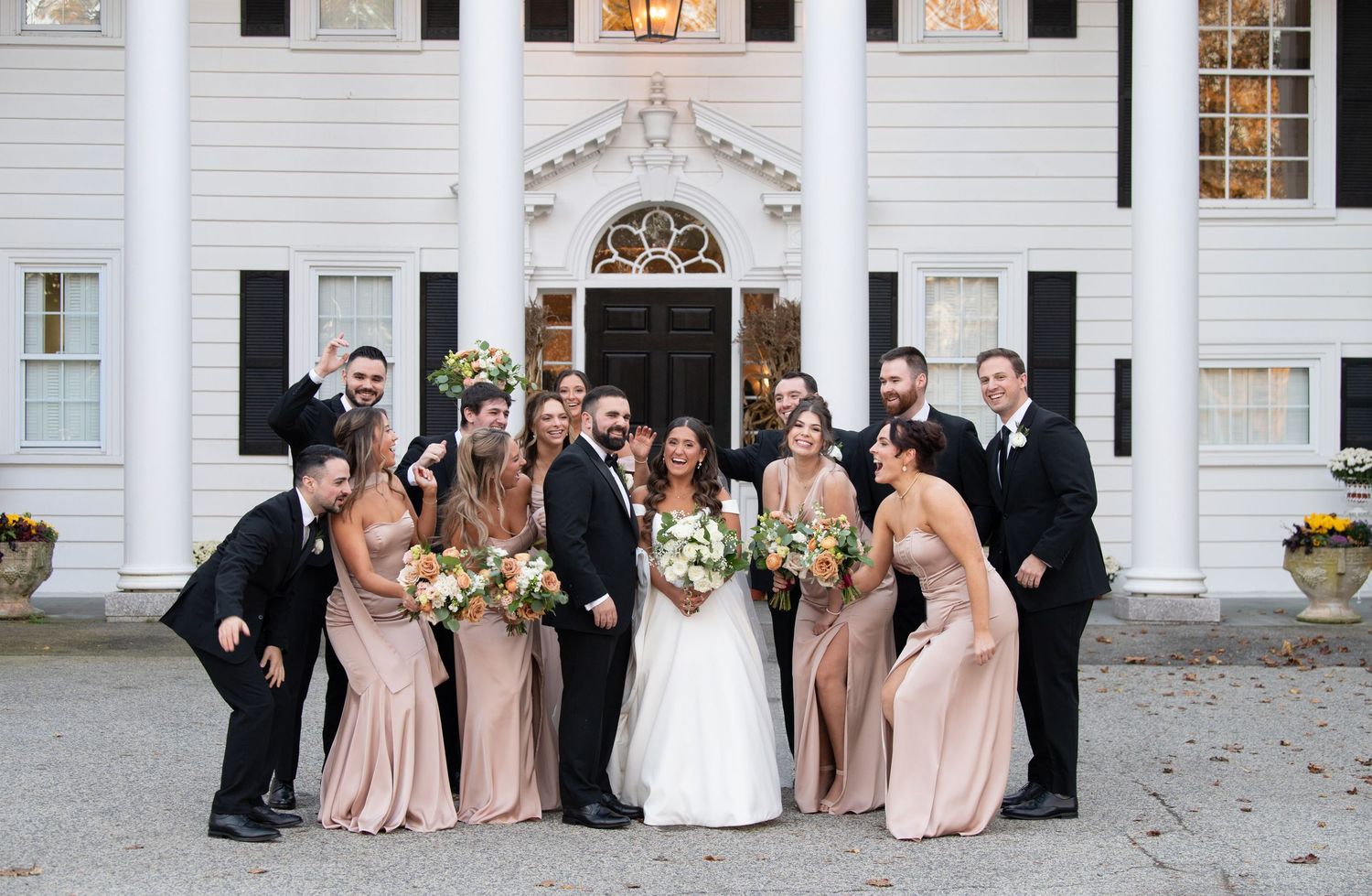 A panoramic collage of wedding party photos taken outside a white colonial style building with elegant columns and windows.