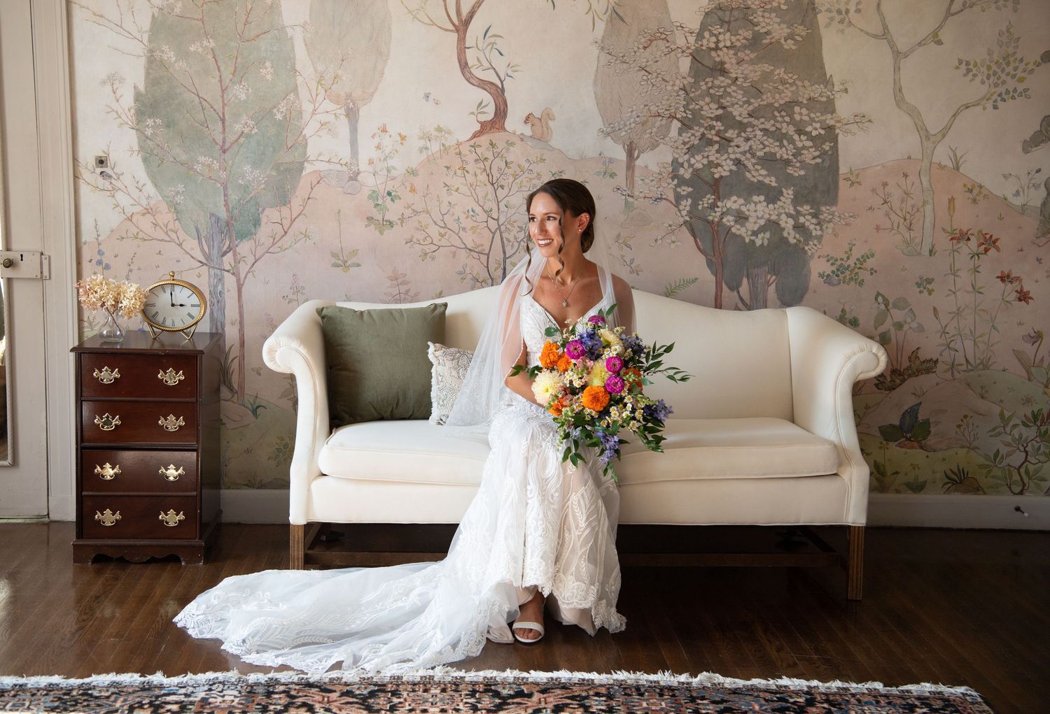 Elegant wedding photo session in a room with vintage wallpaper and white furniture.