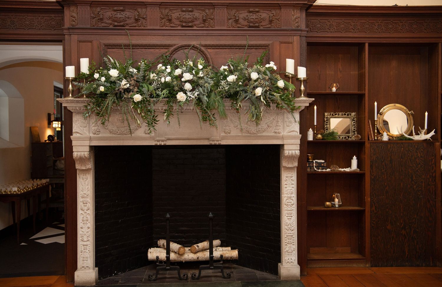 Elegant wedding venue decorated with white floral arrangements and stone architectural elements creating a romantic ambiance.
