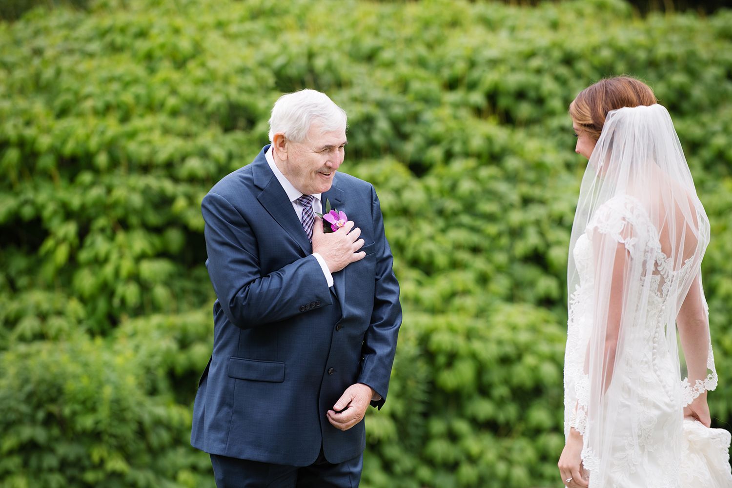 A series of candid wedding photos showing first look reactions in a lush garden setting.