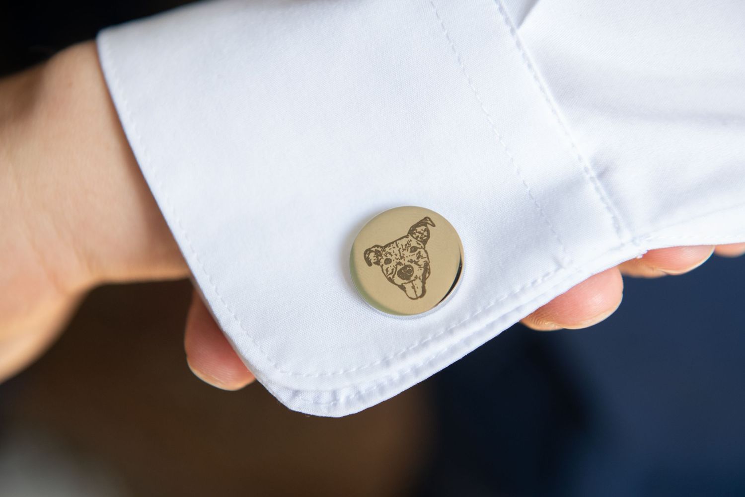 Close-up detail shot of white fabric with embossed decorative elements.