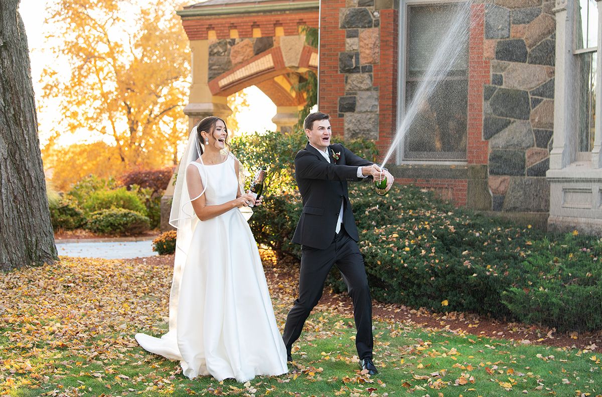 A wedding couple popping champagne. Willowdale estate couple
