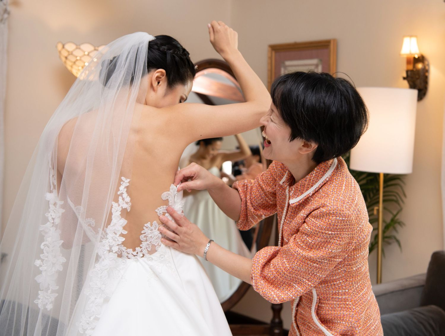 Couple sharing intimate moments during their wedding photography session in a warmly lit indoor setting.