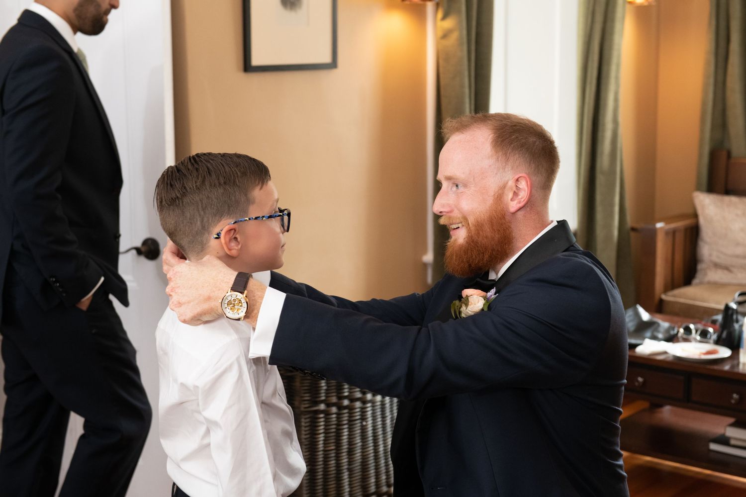 Groomsmen and wedding party members gather for a candid moment during pre-wedding preparations.
