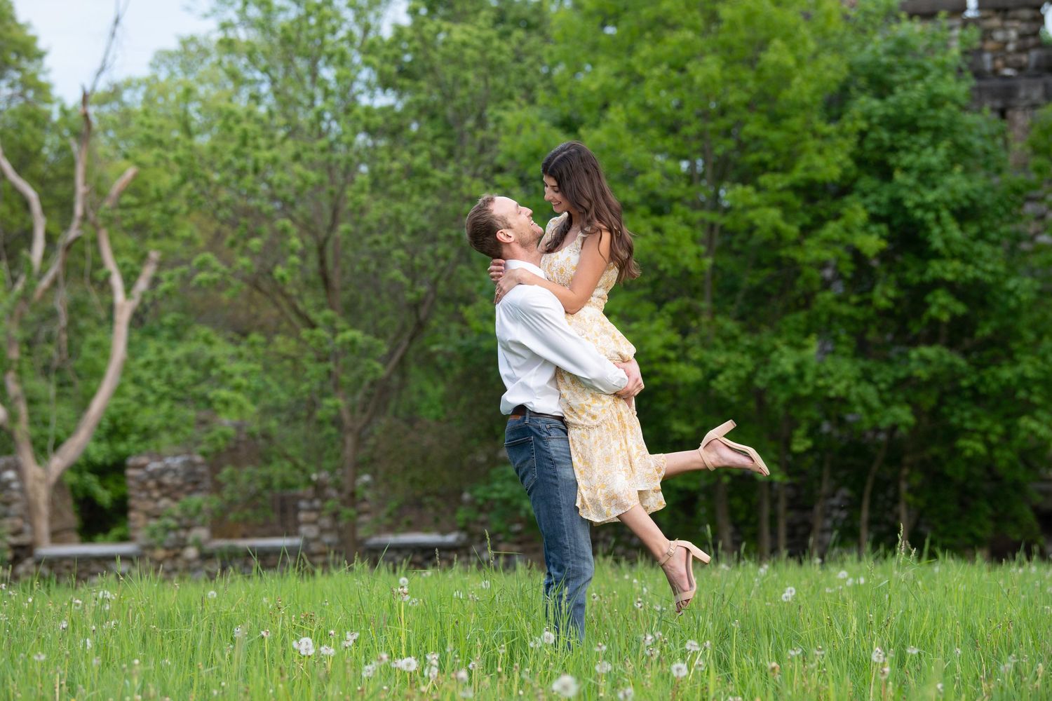 A series of four photographs showing a couple dancing and embracing together in a lush green outdoor setting.