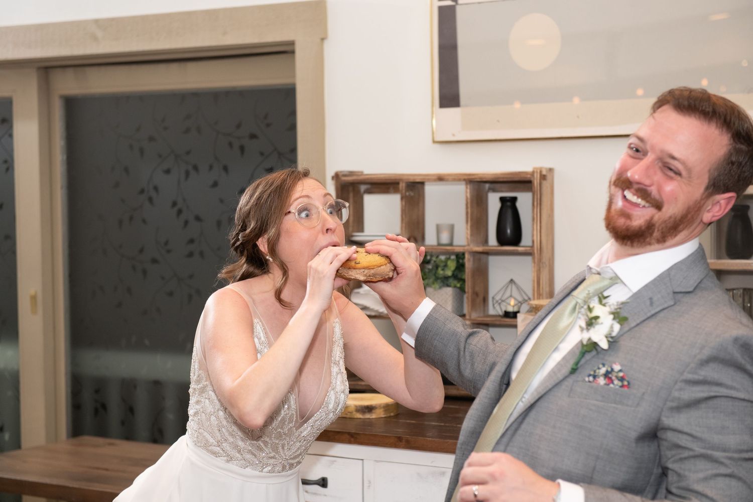 Candid moments of couple enjoying food and laughter during wedding reception.