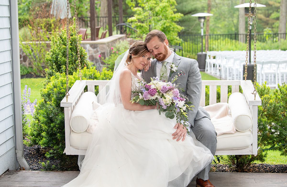 A collection of romantic wedding photos showing tender moments in a lush garden setting with white decor.