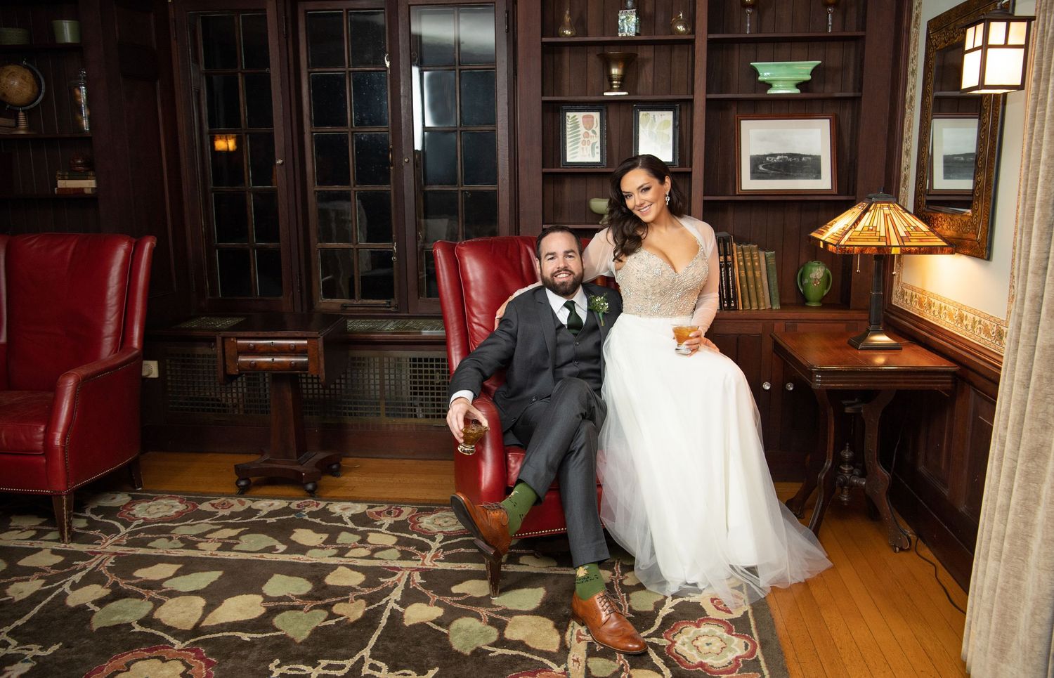 Elegant wedding reception venue with vintage furniture and warm lighting creating a cozy indoor atmosphere.
