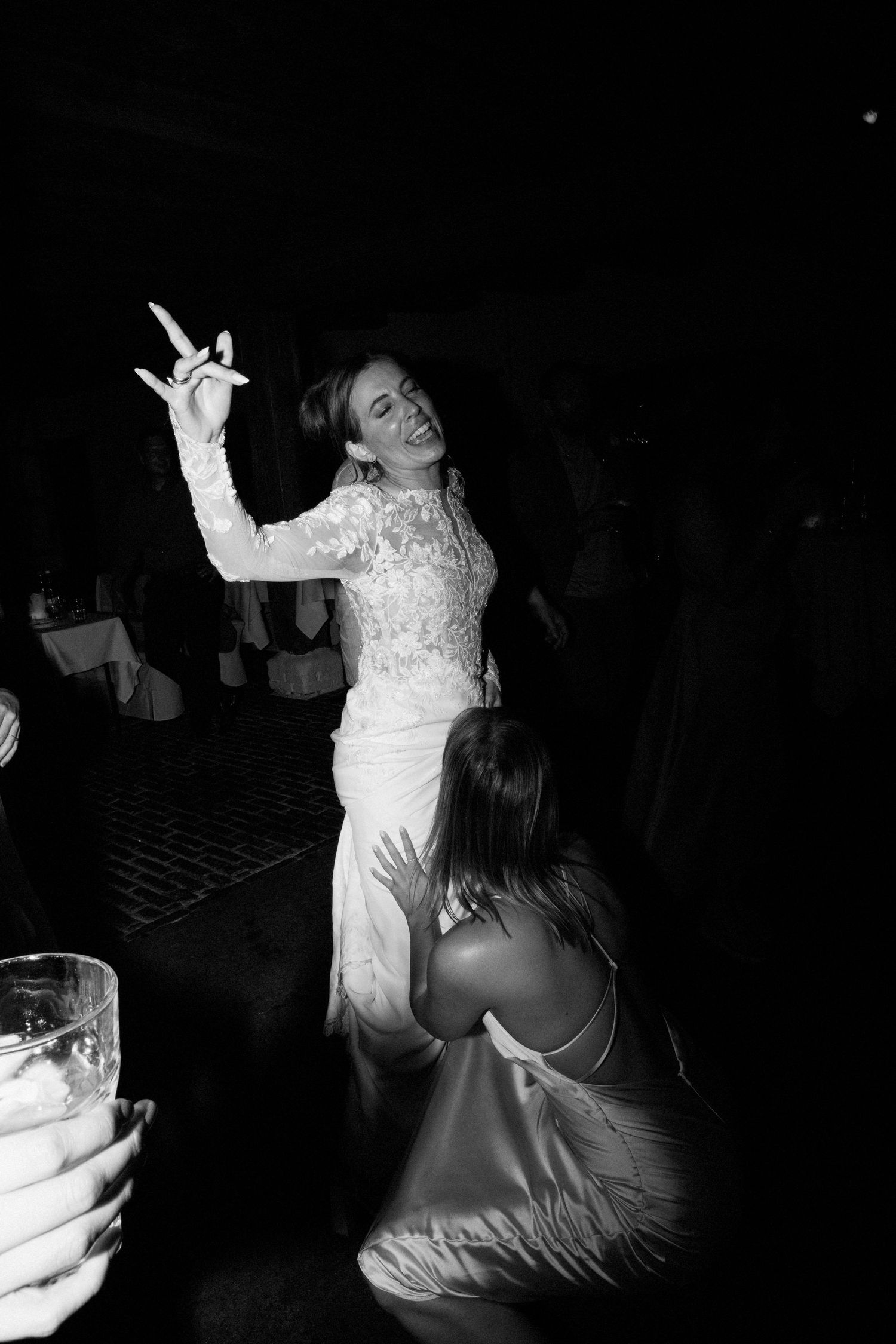 A sequence of black and white photos showing someone in a white dress dancing at what appears to be a party or celebration.