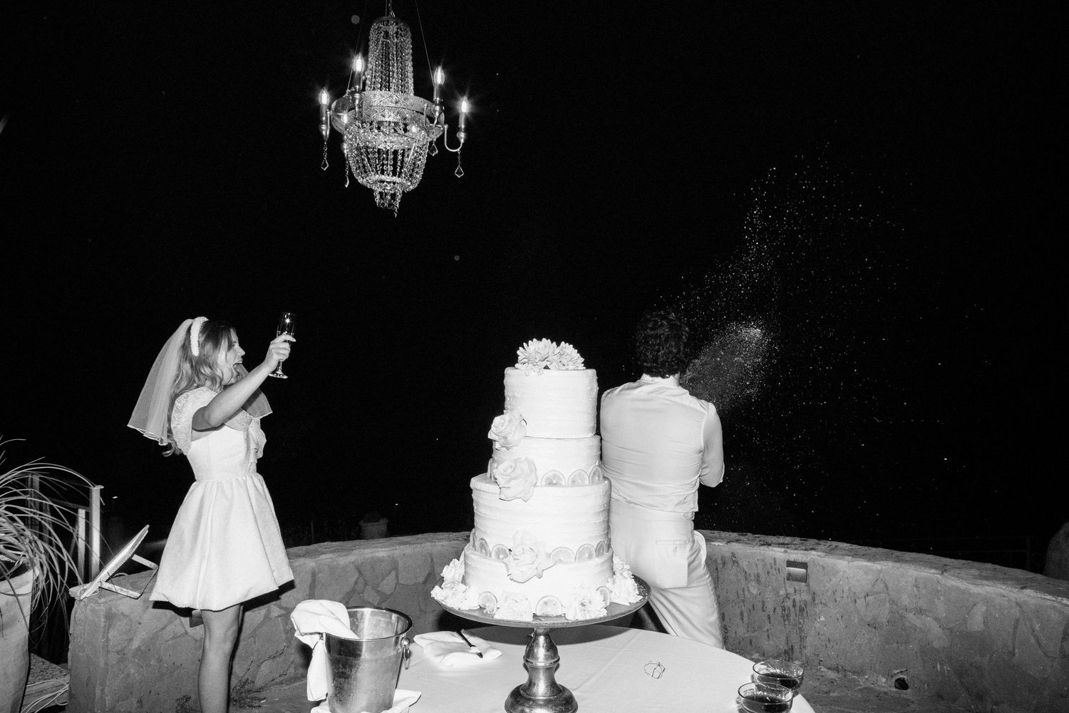 A black and white wedding photo collage showing dance floor moments and wedding cake details at a reception.