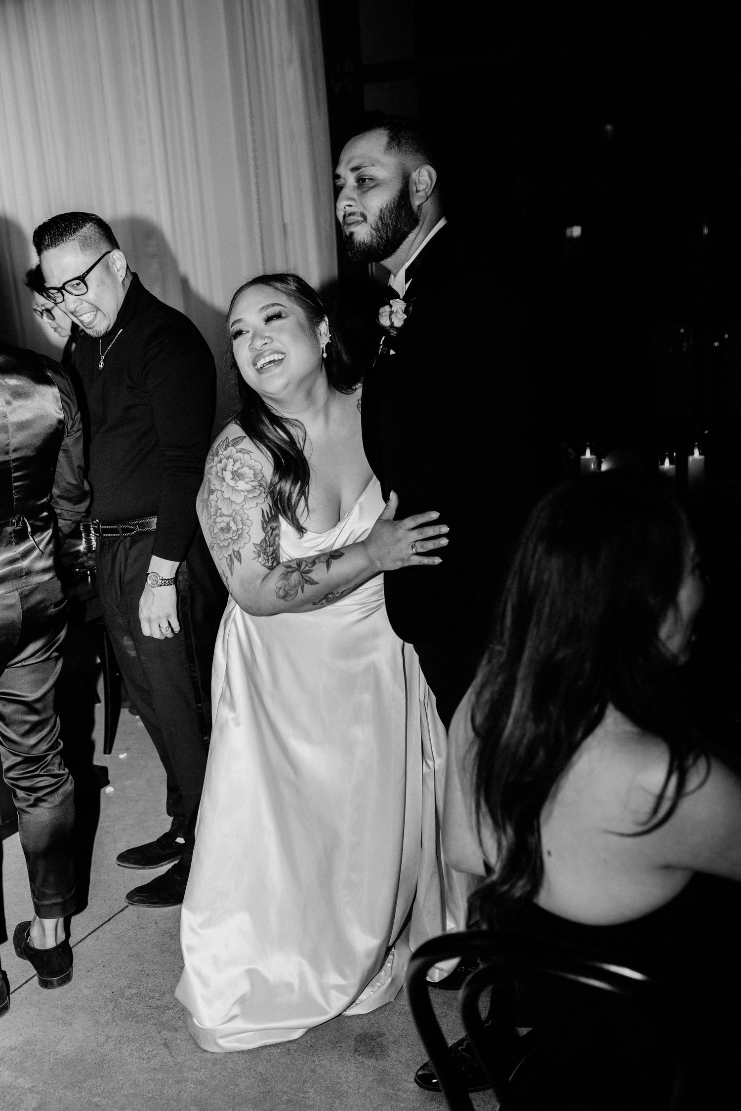 Wedding guests dancing and celebrating in candid black and white photos showing joyful moments on the dance floor.