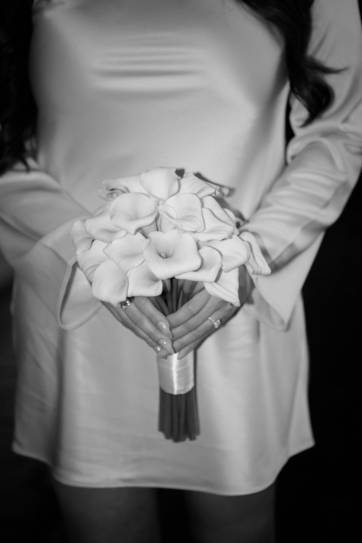 A series of black and white photos showing a person holding white calla lily flowers against a white background.