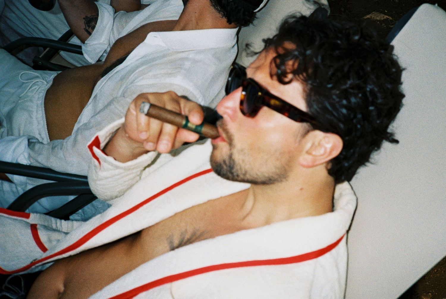 A sequence of five similar photos showing someone sleeping in a white t-shirt with red stripes.