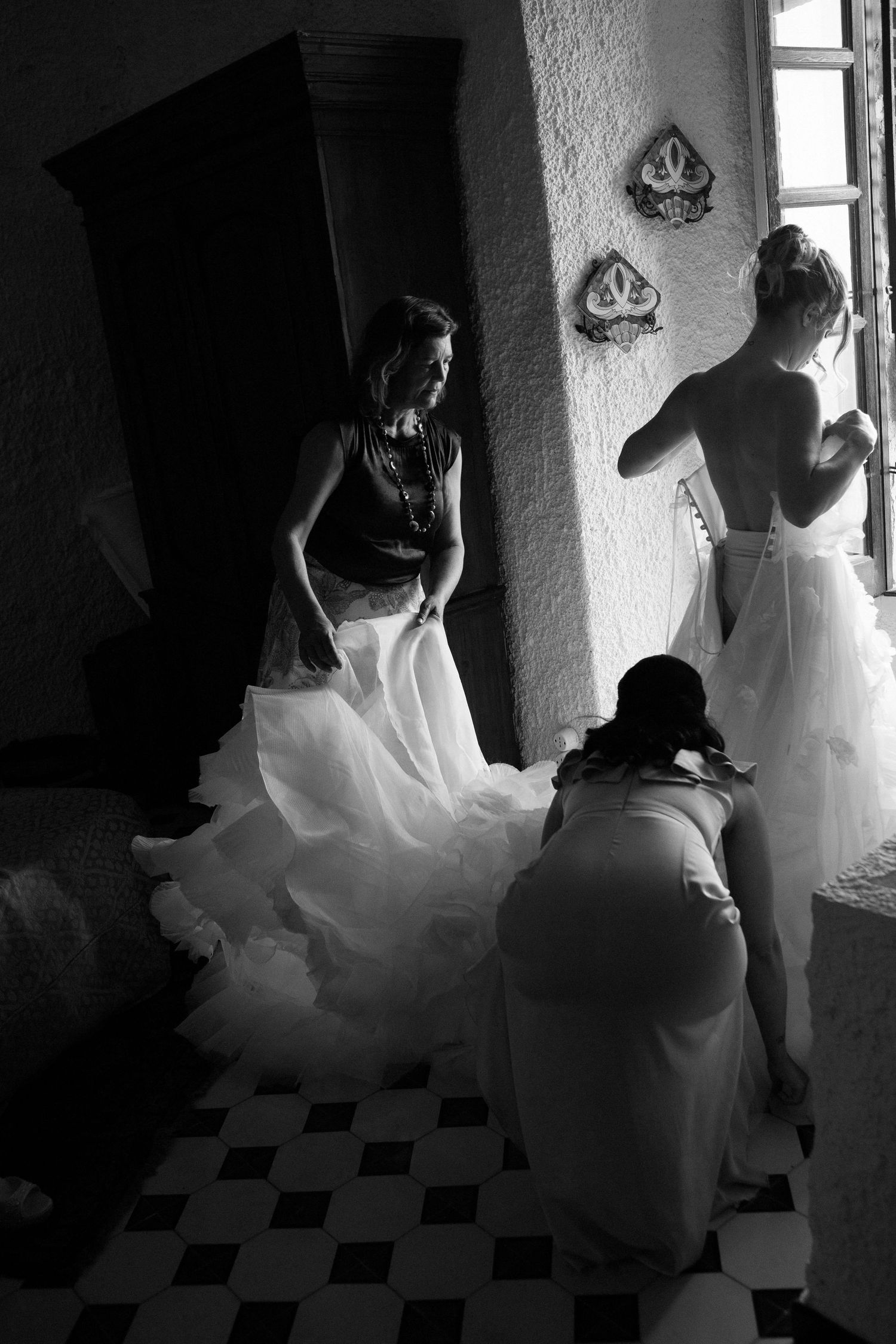 A series of black and white photos showing a bride in a flowing white dress twirling in sequence against a dark background.