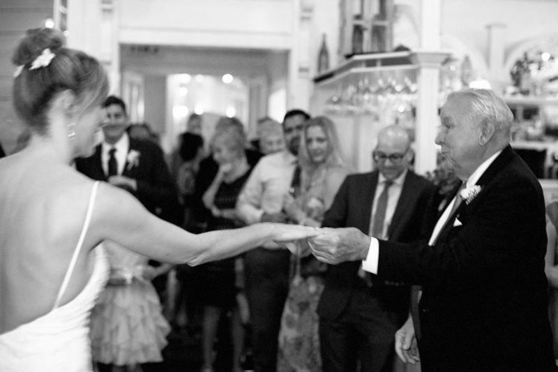 A black and white collage of wedding reception photos showing guests dancing and socializing at a formal event.
