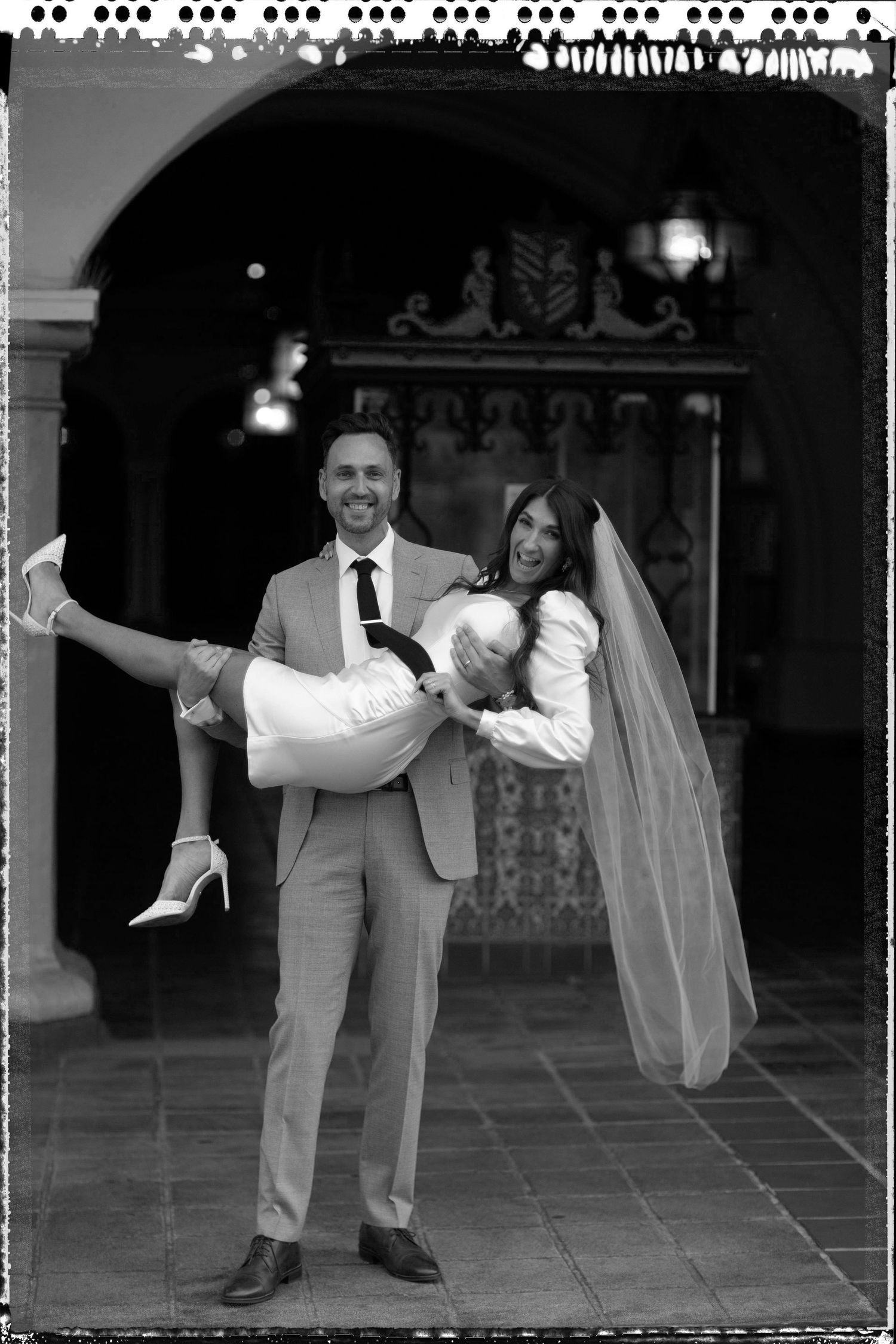 Black and white photo sequence showing a groom lifting and carrying his bride in a playful moment at their wedding.